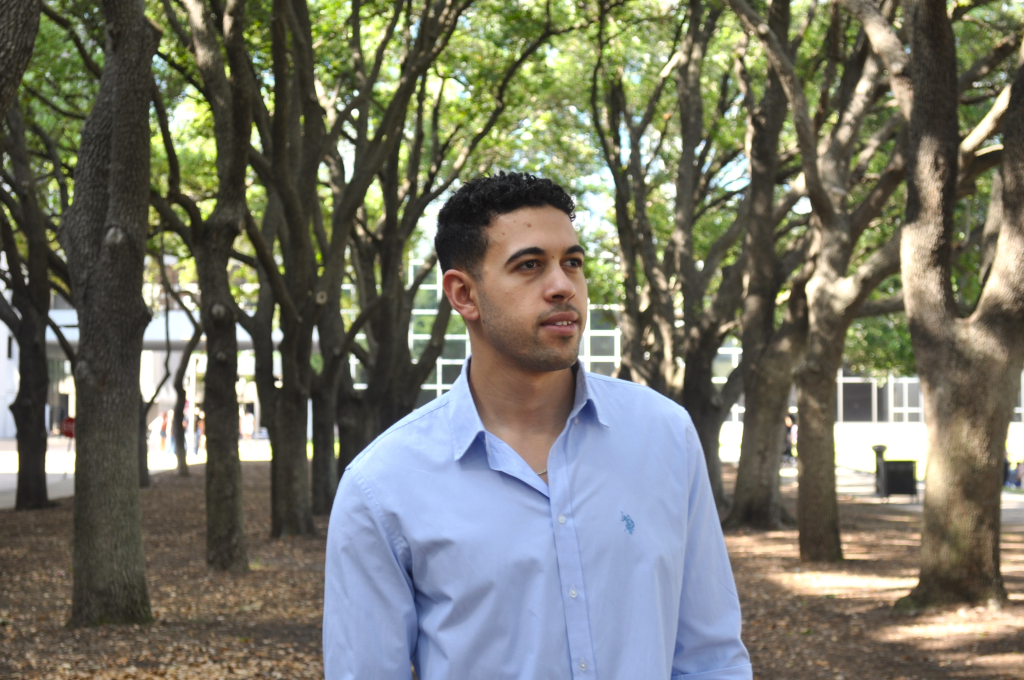 Mahmoud Zaqout looking to his left with trees in the background.
