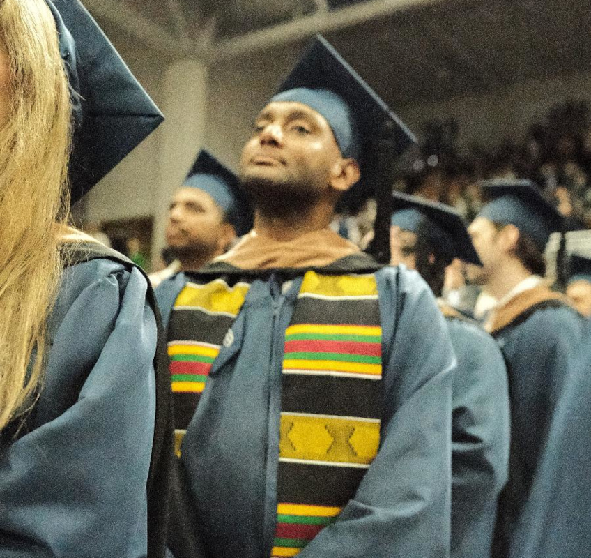 Nebiyu at graduation with his gown